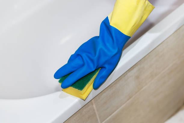 istock House cleaning. Woman cleaning a bath. 859735298