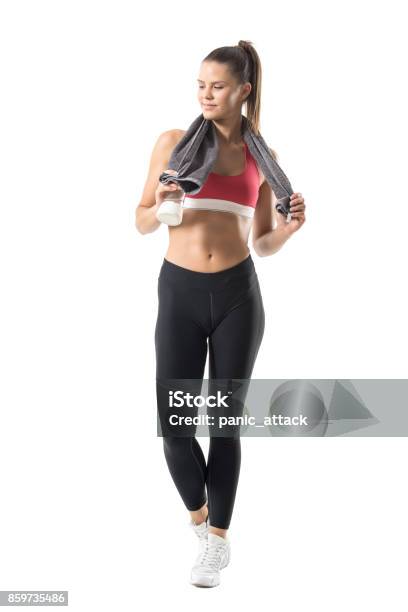 Fit Healthy Sporty Woman With Glass Water Bottle And Towel Around Neck Smiling Stock Photo - Download Image Now