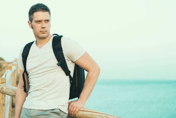 istock Handsome male tourist with backpack. Space for text. 859736014