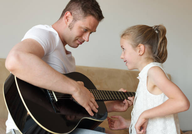 istock Dad plays the guitar for his daughter. 859736416