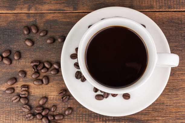 istock coffee cup with coffee bean on wooden background 859739766