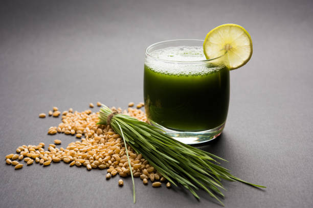 istock Ayurvedic or medicinal Wheat grass juice with lemon slice in glass, selective focus 859744216