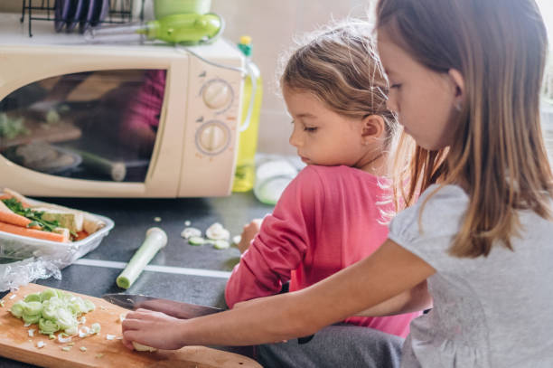 istock Kids preparing food in kitchen 859744290