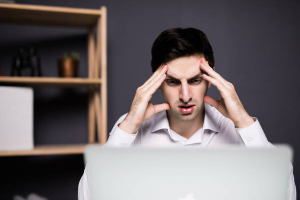 istock business man working problem using laptop looking at screen, hold head hand pain, ache, businessman tired, overworked sitting at the desk stress, at office, computer error concept 859744408