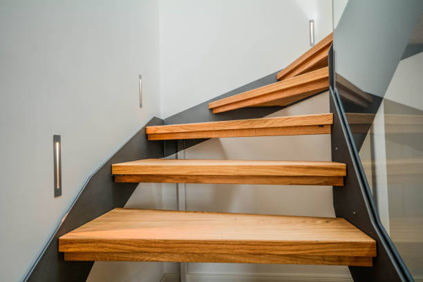 modern steel staircase with wooden steps in a new apartment in a residential building - chancellery imagens e fotografias de stock