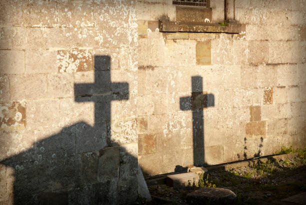 istock Shadows of two crosses on a wall 859751902
