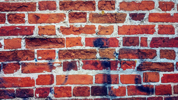 istock Brick wall made of red stone background. The spoiled brick is vintage. 859753366