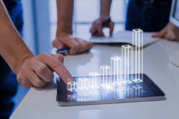 Team analyzing 3D AR chart, tablet computer, growing chart, investment success Team of business people analyzing 3D augmented reality chart above digital tablet computer screen showing growing results and investment success, technology sales executive stock pictures, royalty-free photos & images