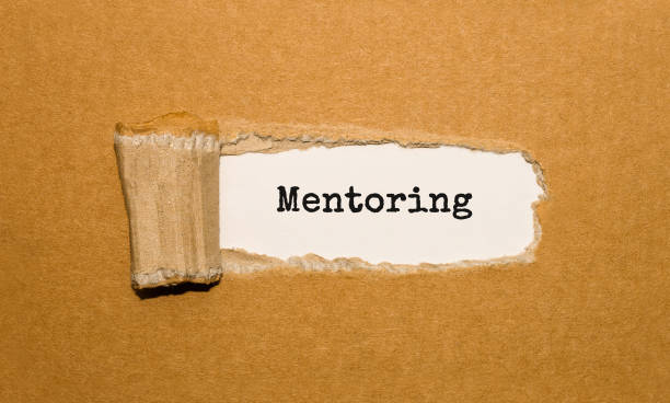 istock The text Mentoring appearing behind torn brown paper 859767078