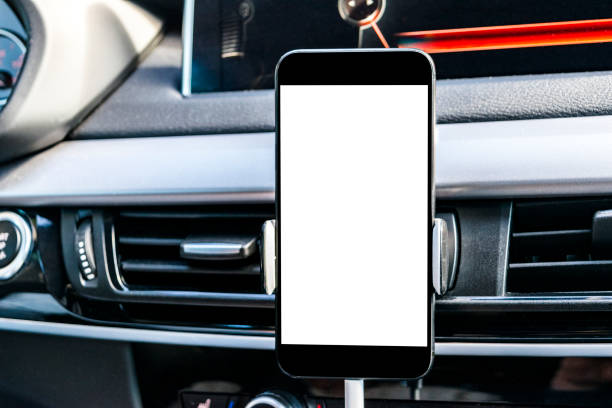 istock Smartphone in a car use for Navigate or GPS. Driving a car with Smartphone in holder. Mobile phone with isolatede white screen. Blank empty screen. copy space. Empty space for text. modern car interior details. 859767416