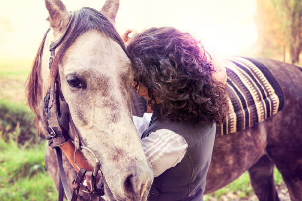 istock horsewoman embraces his horse with affection 859767592