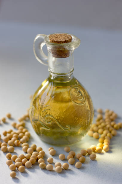 istock Natural and organic soybean oil with soy beans around it. 859774864