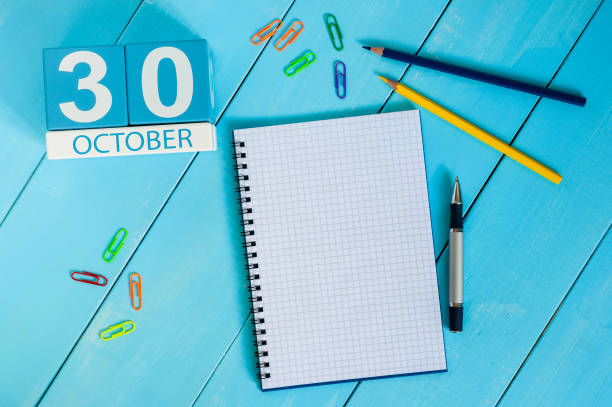 istock October 30th. Image of October 30 wooden color calendar on blue background. Autumn day. Empty space for text 859778498