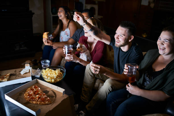 istock group of passionate friends cheering while watching game on tv 859778788
