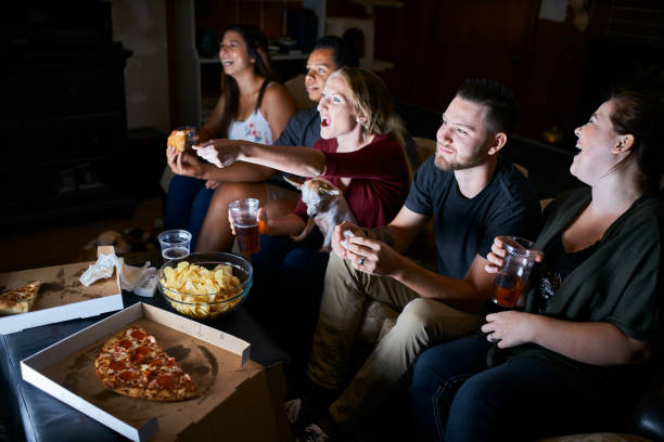 istock group of passionate friends cheering while watching game on tv 859778792