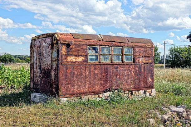istock Iron rusty container with windows on the meadow in the grass 859778826