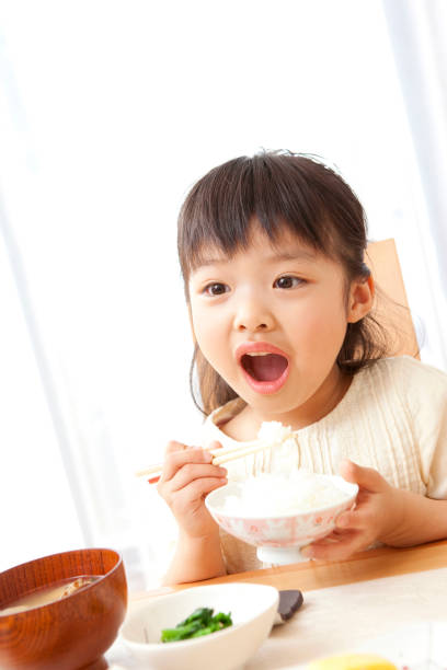 istock Girl eating 859780450