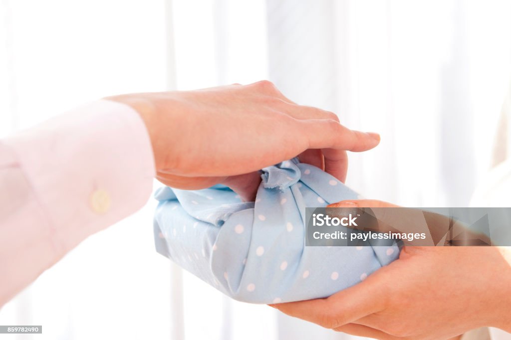 Wife Giving Lunch To Her Husbands Hand Stock Photo - Download Image Now