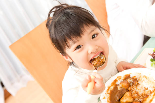 Girl eating Curry and rice