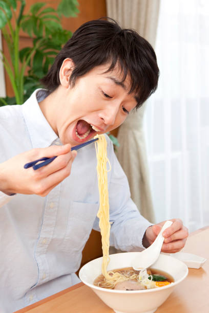 istock Men eat soy sauce ramen 859784190