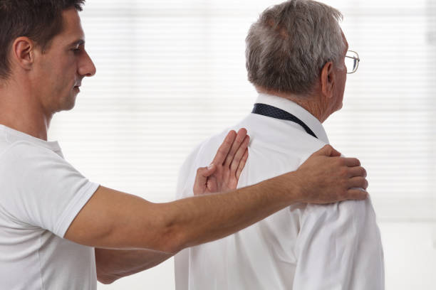 istock Chiropractic back adjustment. Osteopathy concept. Senior Male patient suffering from back pain and physical therapist 859788502