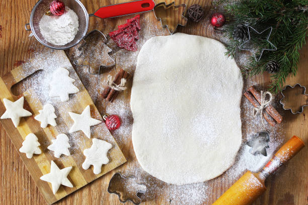 Cooking butter biscuits of different shapes on a wooden table