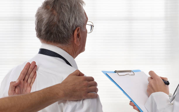 istock Senior male patient suffering from back pain during chiropractic back adjustment. Osteopathy, Physiotherapy concept. 859792570