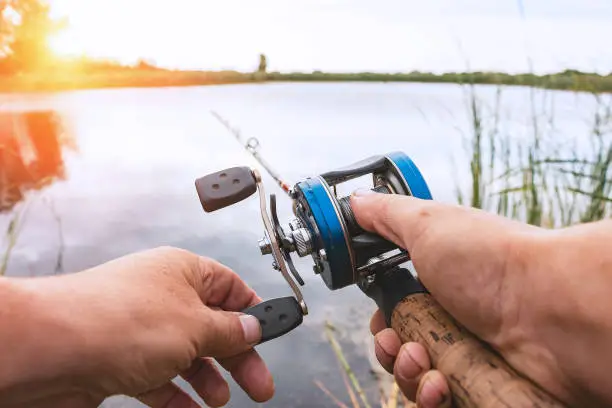 Photo of Man is fishing with a backcasting reel