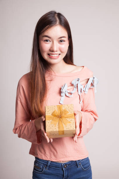 istock Young Asian woman with a gift box. 859799130