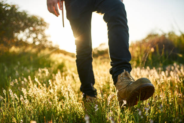 istock close up of hikers boot while walking through grass during hike 859800012