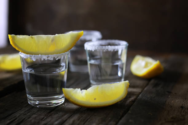 istock stack of tequila with salt and lemon on a wooden background 859803110