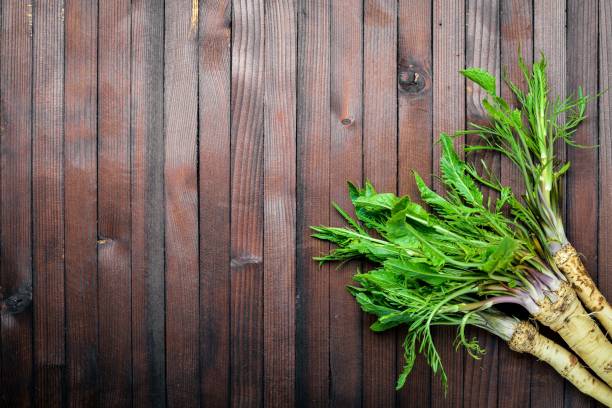 istock Fresh horseradish. In brown Wooden table. Top view. 859804218