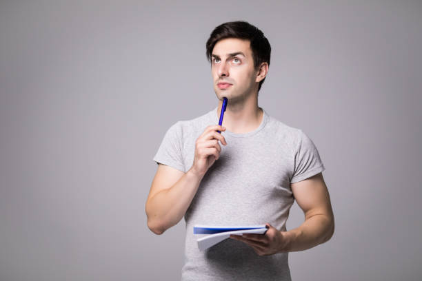 istock Young man holding opened black notebook in his hands. Close up view 859807100