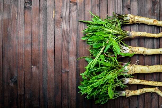 istock Fresh horseradish. In brown Wooden table. Top view. 859812926