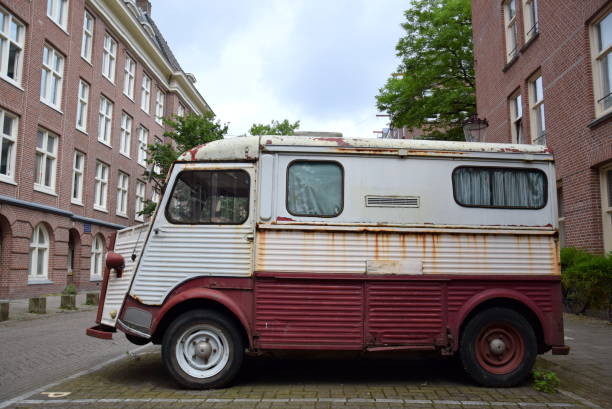An old and rusty Citroen Type H truck parked in the street AMSTERDAM; NETHERLANDS - JUNE 10, 2017: An old and rusty Citroen Type H truck parked in the street citroen hy stock pictures, royalty-free photos & images