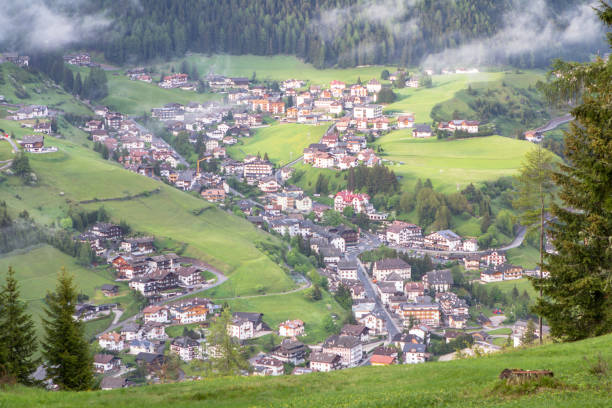 istock Alpine village in the mist clouds 859818262