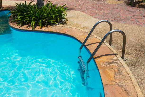 istock Grab bars ladder in blue swimming pool 859820636