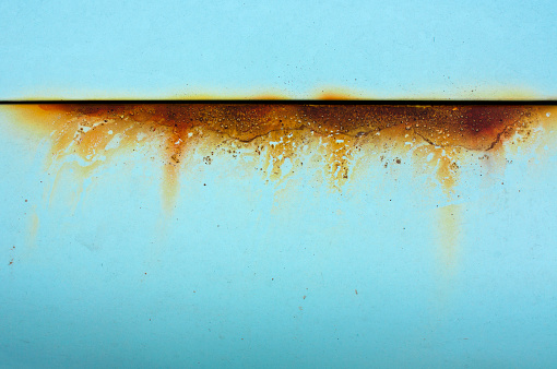 Baby blue metal with rusty orange cut, a detail of an old car