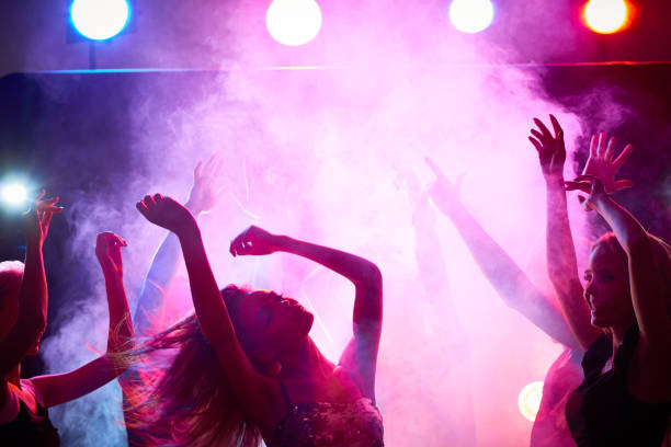 istock Carefree woman dancing in crowd 859824950