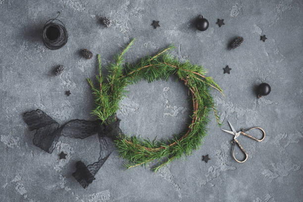 istock Handmade christmas wreath, black decorations. Top view, flat lay 859828178