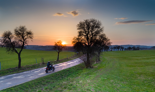 Aerial view of rider on motorcycle during sunset in Czech republic.