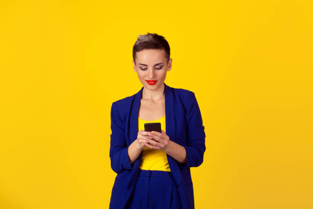 istock Happy young woman holding using new smartphone connected browsing internet worldwide isolated on yellow wall background. 4g data plan provider 859829370