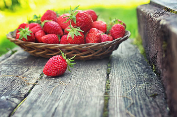 istock Strawberry in wicker plate on wooden background 859829466
