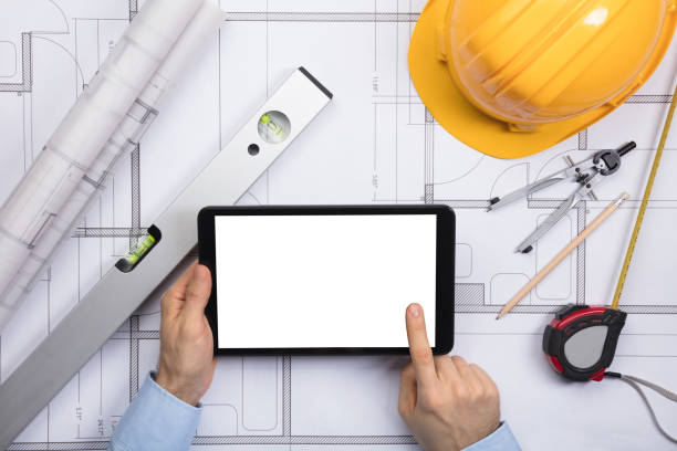istock An Architect Touching The Screen Of Digital Tablet On Blueprint 859829702