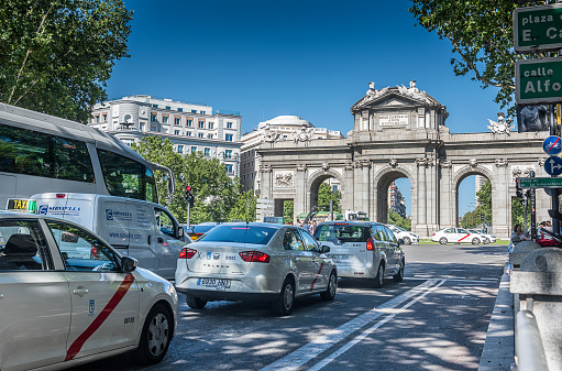 Madrid, Spain - Jun 25, 2017: Taxis around Puerta de Alcala, Madrid, Spain in a summer sunny day.