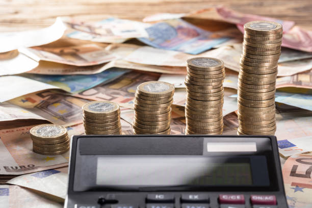 istock Calculator With Coin Stacked And Currency Notes 859832866