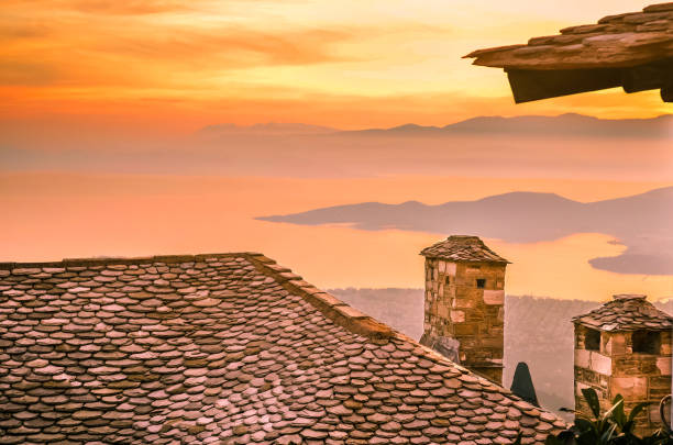 Slate roof with chimneys of a traditional house in Pelion,Greece Amazing view from a slate roof with chimneys of a traditional house in Pelion on the mountain of the gods called Olympos. pilio greece stock pictures, royalty-free photos & images