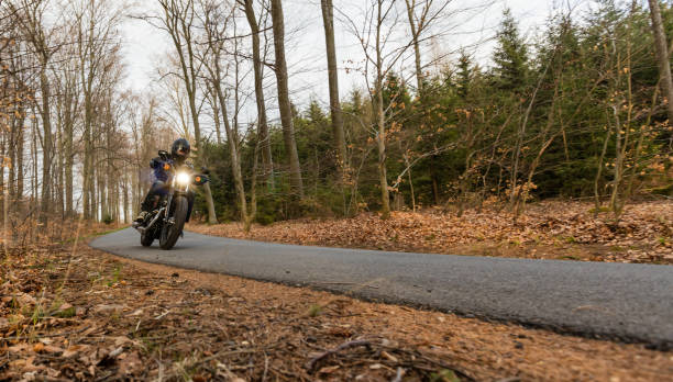 istock Man seat on the motorcycle on the forest road 859837862