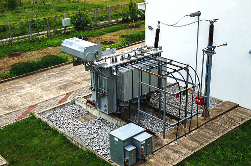 High voltage oil-filled power transformer on electrical substation