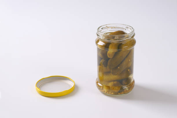 jar of pickled cucumbers on white background